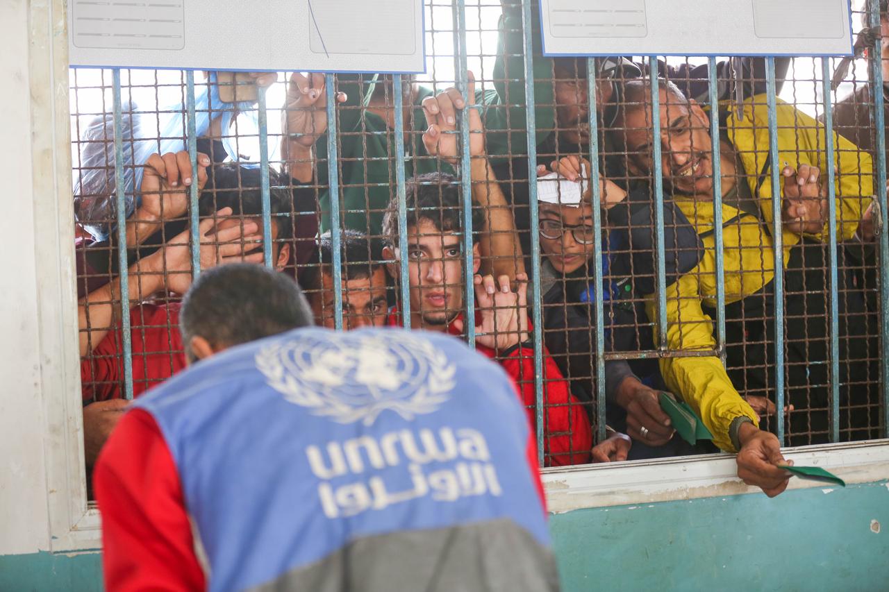 Flooding from heavy rain left displaced Gazans in damaged tents exposed to cold, prompting hundreds to seek new shelters at the UNRWA office in Deir al-Balah on Nov. 15, 2025. (AA Photo)