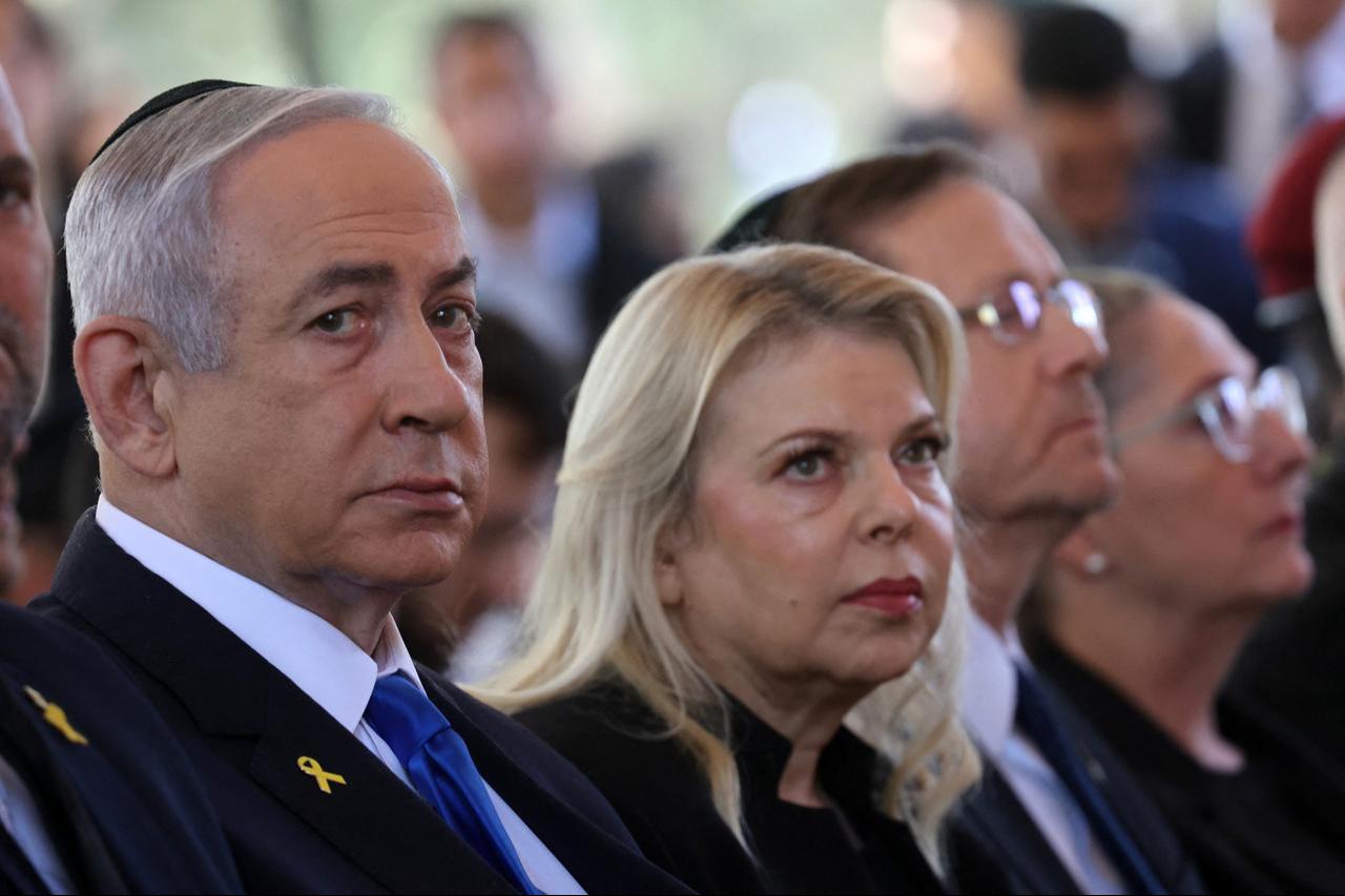 Israel's Prime Minister Benjamin Netanyahu (L) sits with his wife Sara Netanyahu (R) at a ceremony at the Mount Herzl military cemetery in Jerusalem, Israel on Oct. 27, 2024. (AFP Photo)
