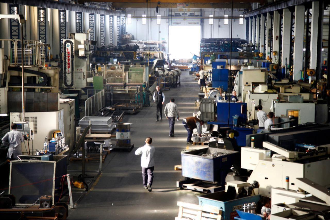Workers operate machinery on the factory floor of a metal manufacturing plant in Türkiye, accessed on June 30, 2025. (Adobe Stock Photo)