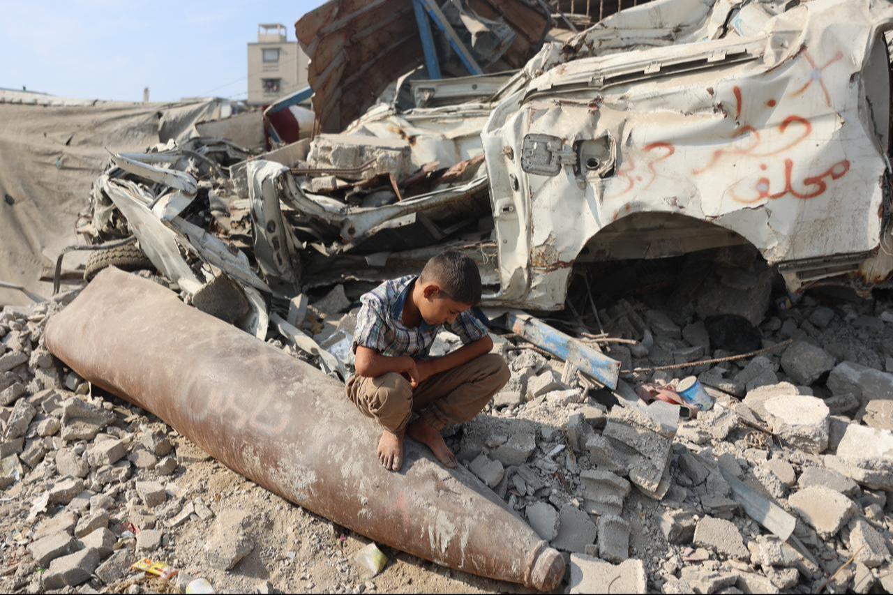 A Palestinian boy sits on an unexploded missile in the Al-Rimal neighborhood of Gaza City on Nov. 12, 2025. (AFP Photo)