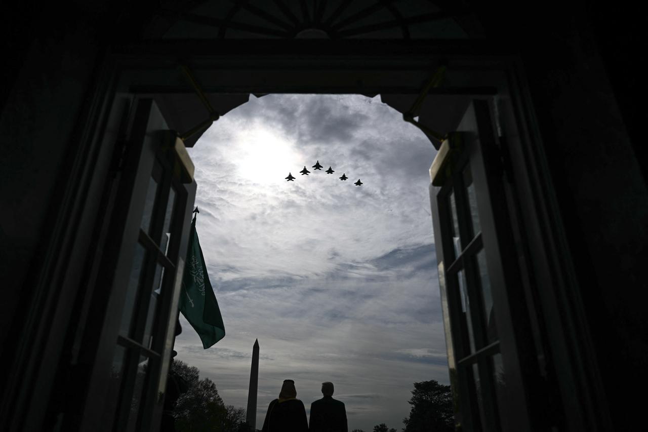 US President Donald Trump and Crown Prince and Prime Minister of the Kingdom of Saudi Arabia Mohammed bin Salman watch a flyover of military aircraft on the South Lawn at the White House in Washington, DC on Nov. 18, 2025. (AFP Photo)