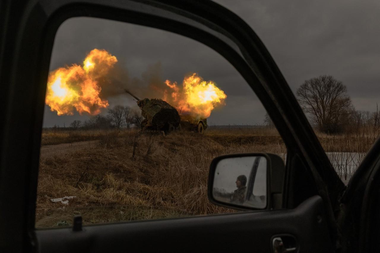 A Ukrainian soldier reflected in a car mirror looks on as a Swedish-made Archer Howitzer operated by Ukrainian members of the 45th Artillery Brigade fires towards Russian positions, in the Donetsk region, Jan. 20, 2024. (AFP Photo)