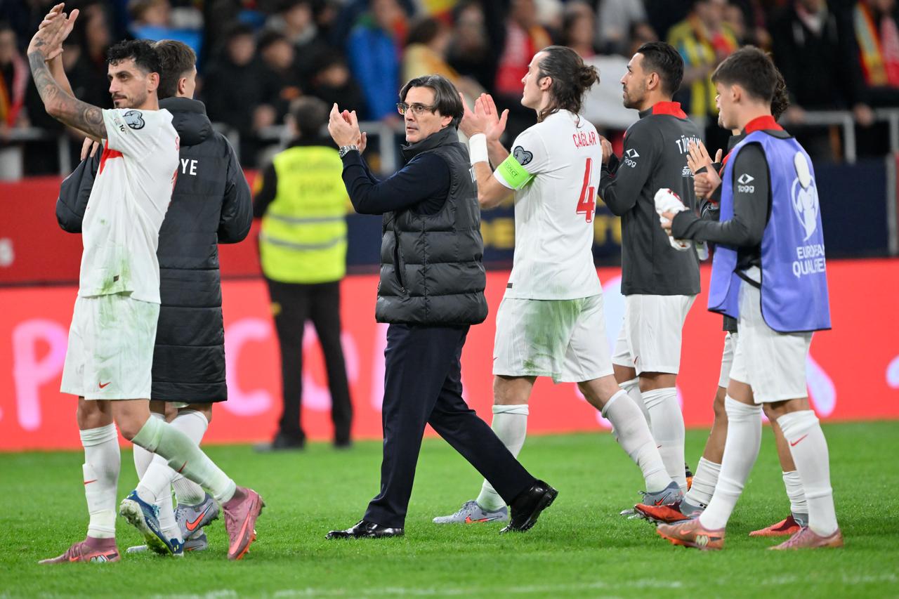 Head coach Vincenzo Montella (C) and players of Türkiye greet their fans at the end of the FIFA World Cup 2026 qualifier football match between Spain and Türkiye at Estadio de La Cartuja in Seville, Spain on November 18, 2025. (AA Photo)