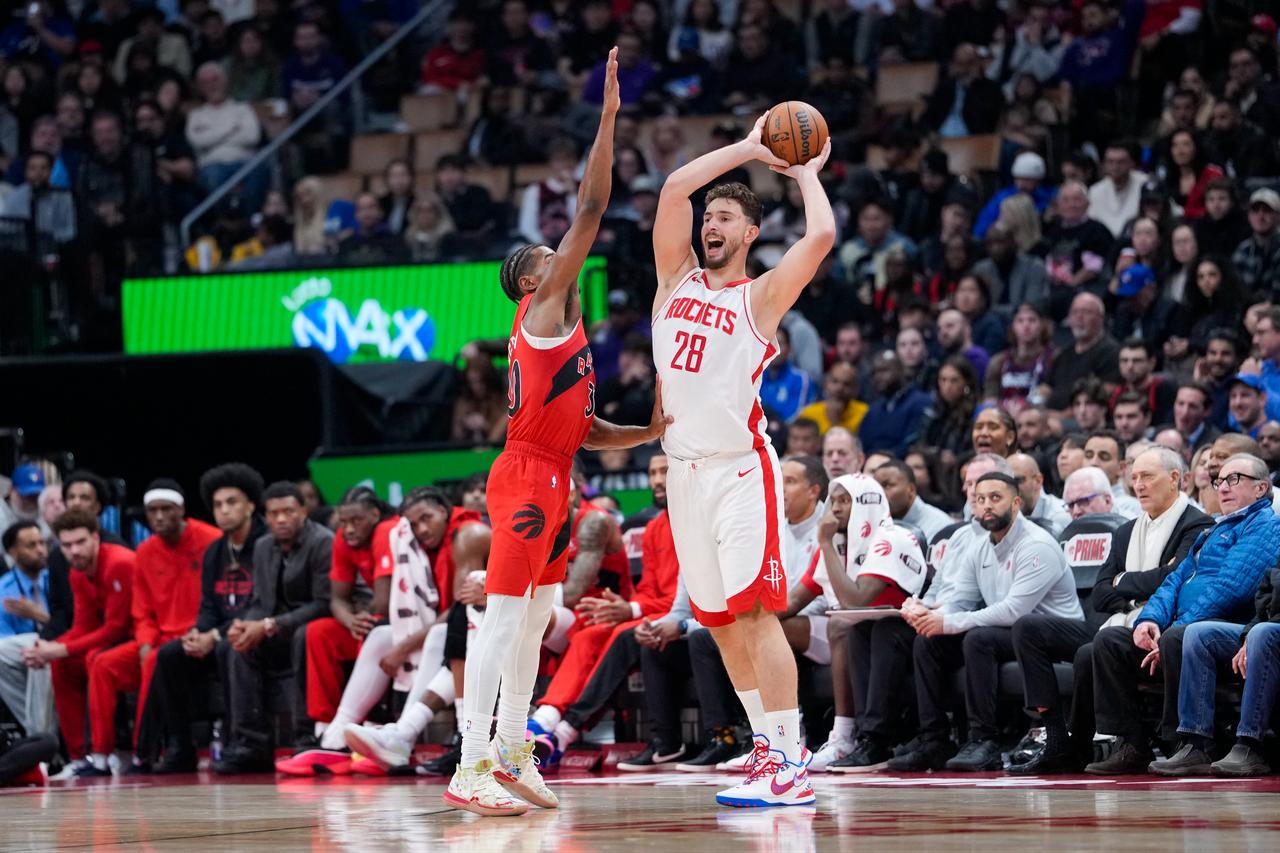 Alperen Sengun #28 of the Houston Rockets protects the ball against Ochai Agbaji #30 of the Toronto Raptors during the first half, Oct. 29, 2025 in Toronto, Canada. (Photo by Kevin Sousa/Getty Images via AFP)
