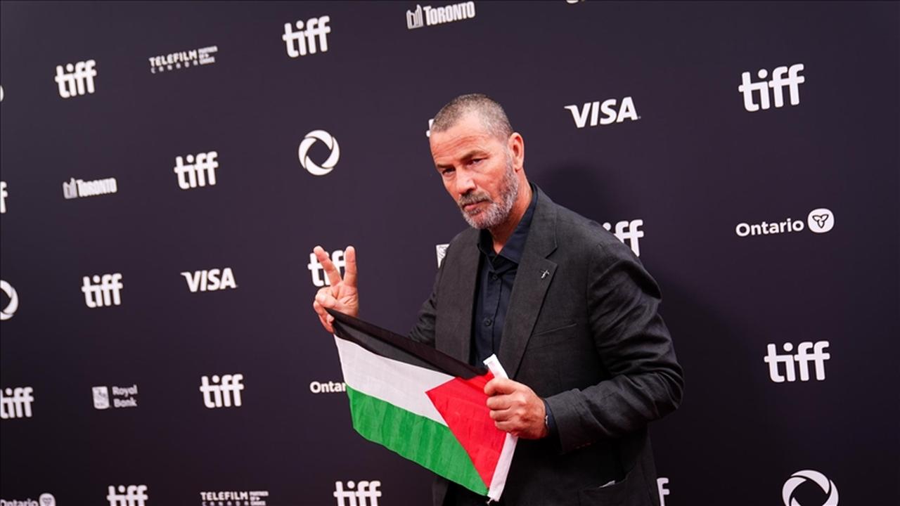 Cast member Saleh Bakri poses while holding a Palestinian flag for the premiere of the film “Palestine 36” as the Toronto International Film Festival (TIFF) returns for its 50th edition, Ontario, Canada, September 5, 2025. (AA Photo)