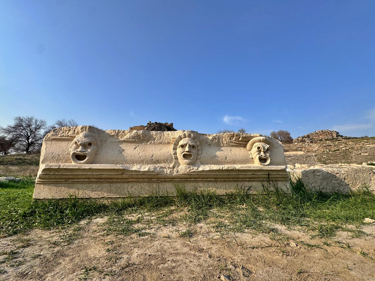 Three theatrical mask reliefs stand aligned after excavation at the ancient city of Kastabala’s Roman theater, Osmaniye, southern Türkiye, Nov. 19, 2025. (AA Photo)