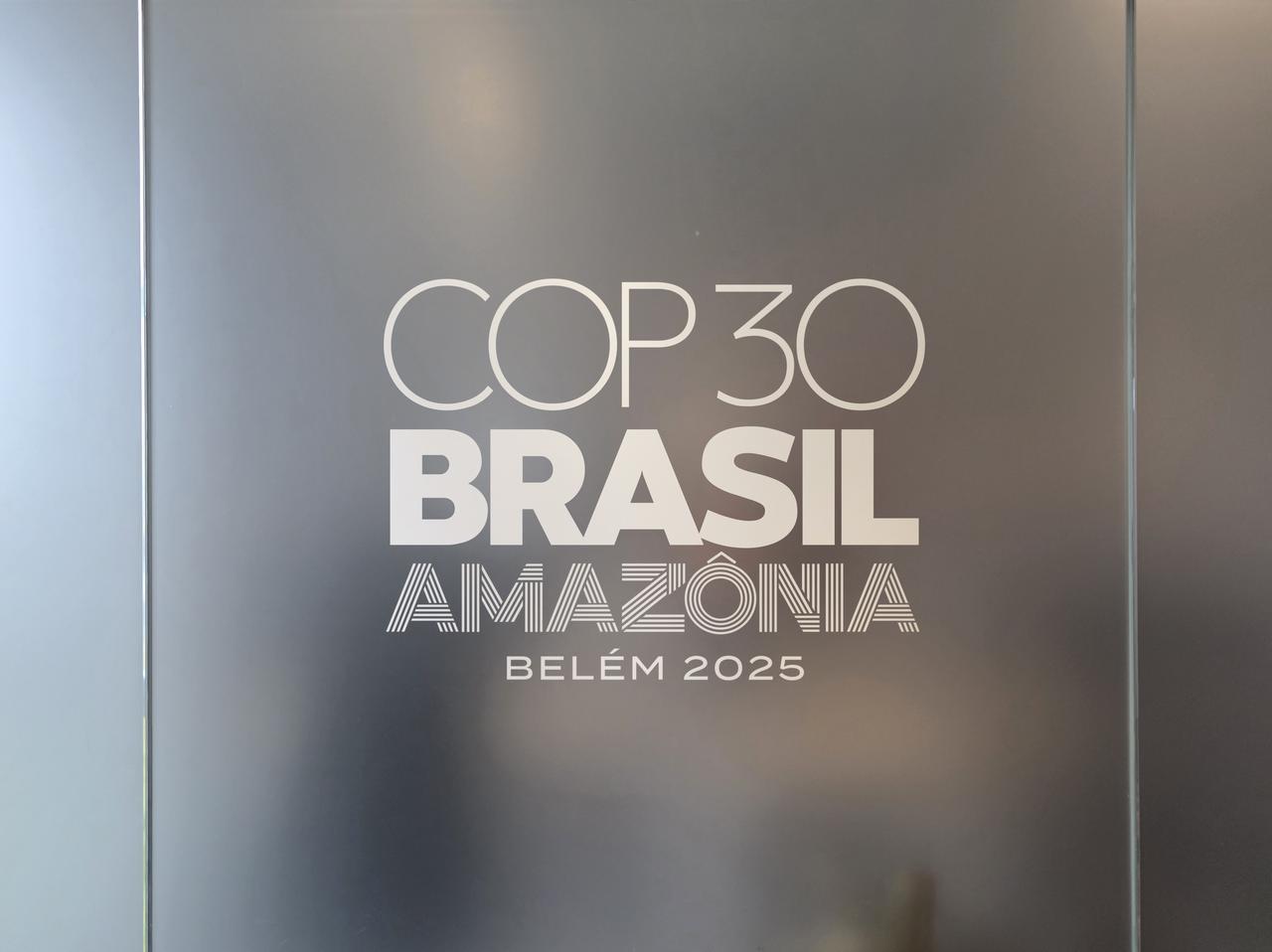 The COP30 Brazil Amazonia Belem 2025 logo is displayed on an indoor window. (Adobe Stock Photo)