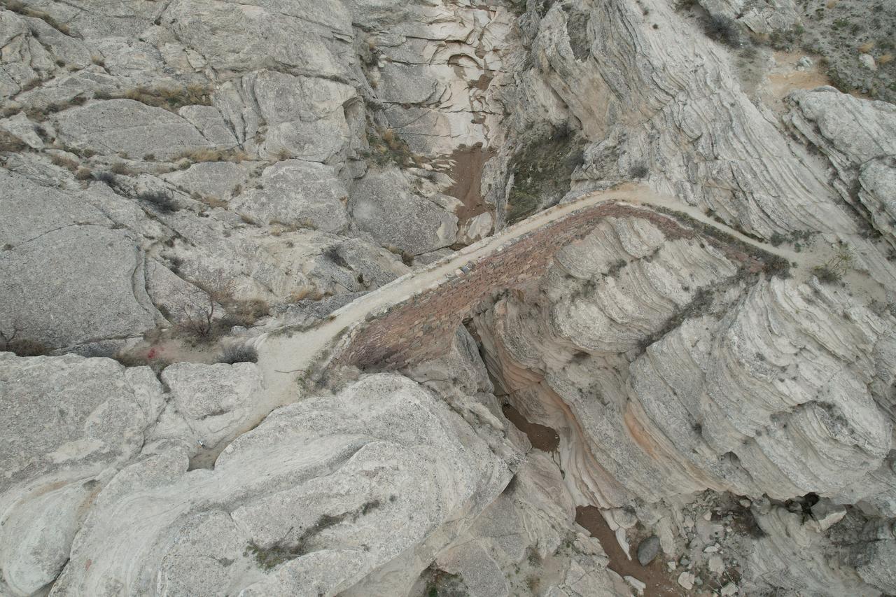 An aerial view shows the steep rocky terrain surrounding Seytan Koprusu, the historic aqueduct-bridge in the Sille valley near Konya, Türkiye, Nov. 22, 2025. (IHA Photo)