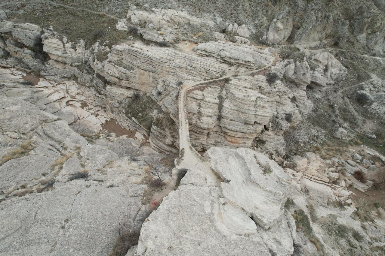 An aerial view shows the steep rocky terrain surrounding Seytan Koprusu, the historic aqueduct-bridge in the Sille valley near Konya, Türkiye, Nov. 22, 2025. (IHA Photo)