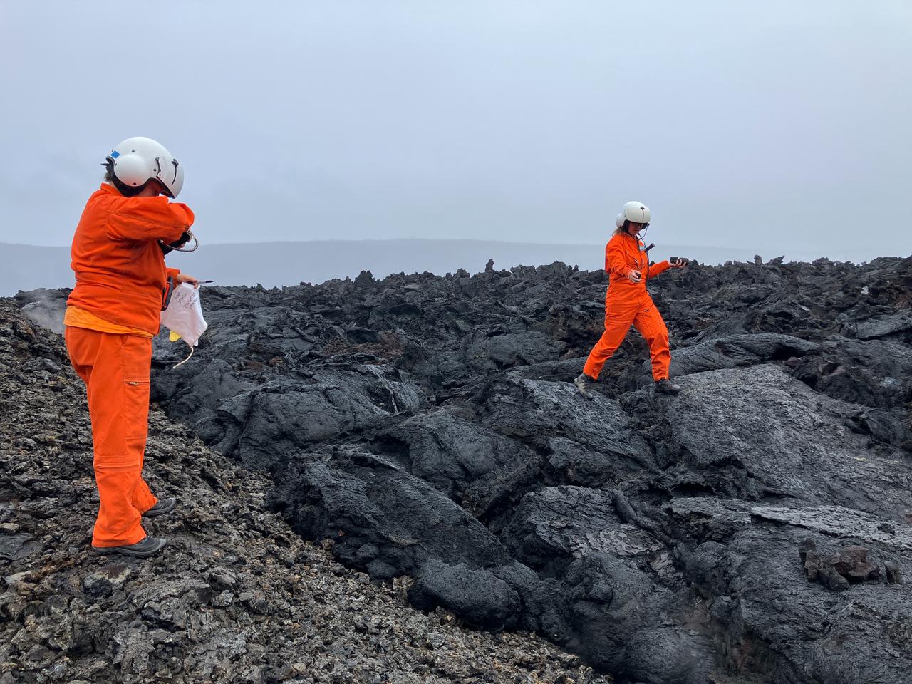 USGS Hawaiian Volcano Observatory scientists collect solidified lava samples from previous eruption episodes on the floor of Halemaumau crater at Kilauea’s summit in Hawaii, Nov. 21, 2025. (Photo by M. Zoeller/USGS)