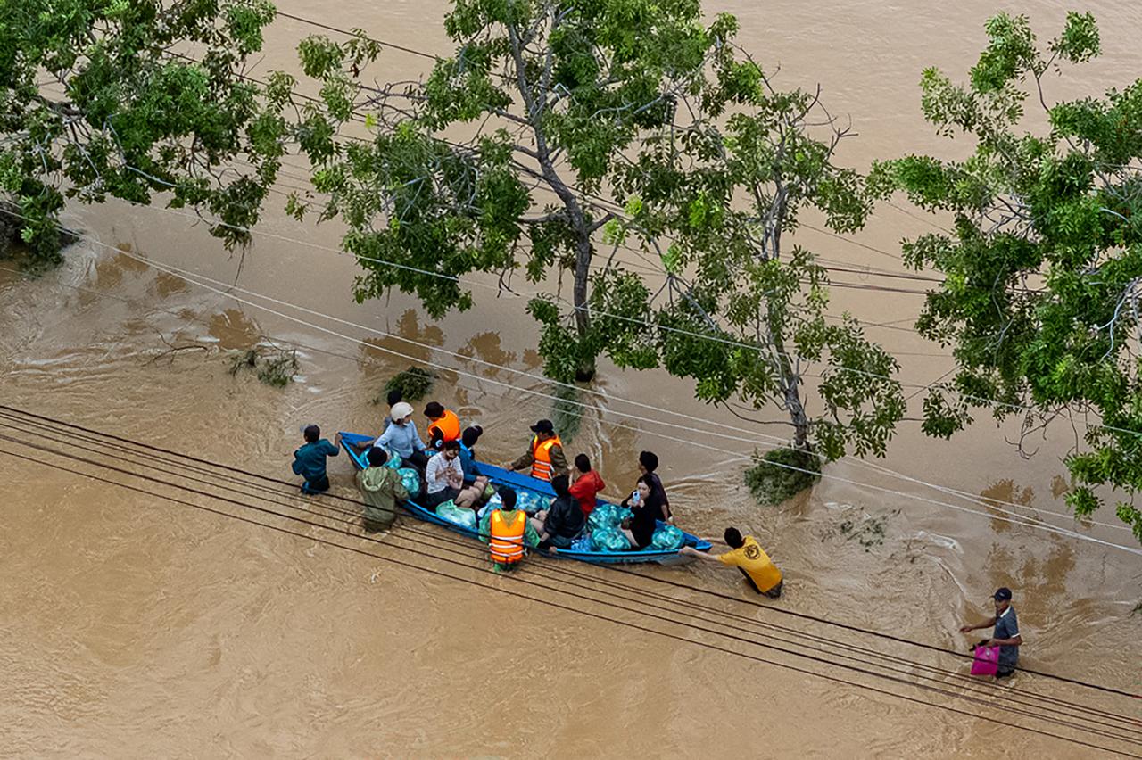 An aerial view of residents wading through floodwaters in Phan Rang, Khanh Hoa province. Vietnam, November 21, 2025. (AFP Photo)