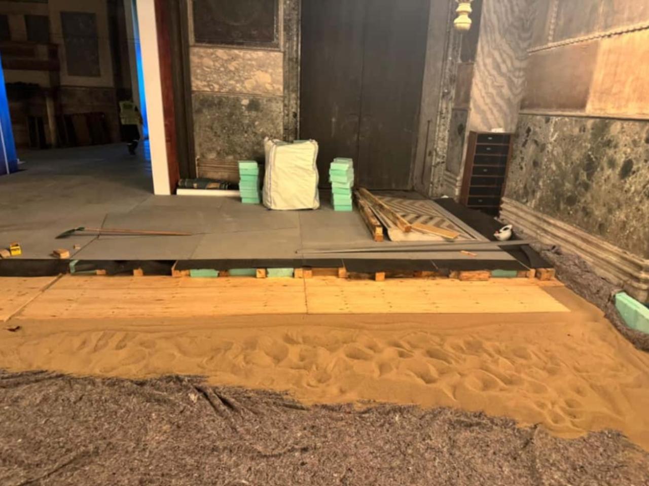 Workers prepare the multi-layer protection system at the Imperial Gate entrance using felt, silica sand, timber grid, insulation blocks, plywood and protective steel sheets, Hagia Sophia Grand Mosque, Istanbul, Türkiye. (Photo courtesy of Ministry of Culture and Tourism)