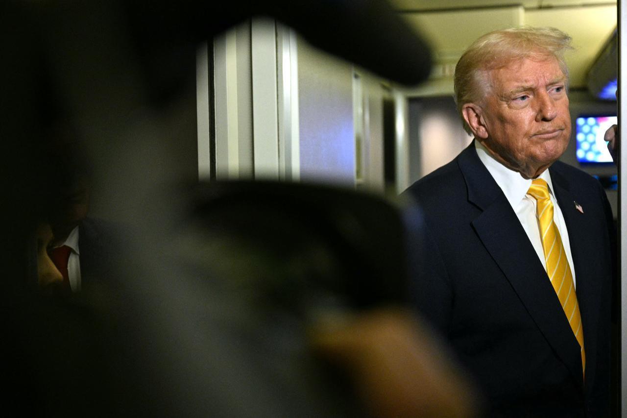 U.S. President Donald Trump speaks to reporters aboard Air Force One en route to Palm Beach, Florida, on Nov. 14, 2025. (AFP Photo)
