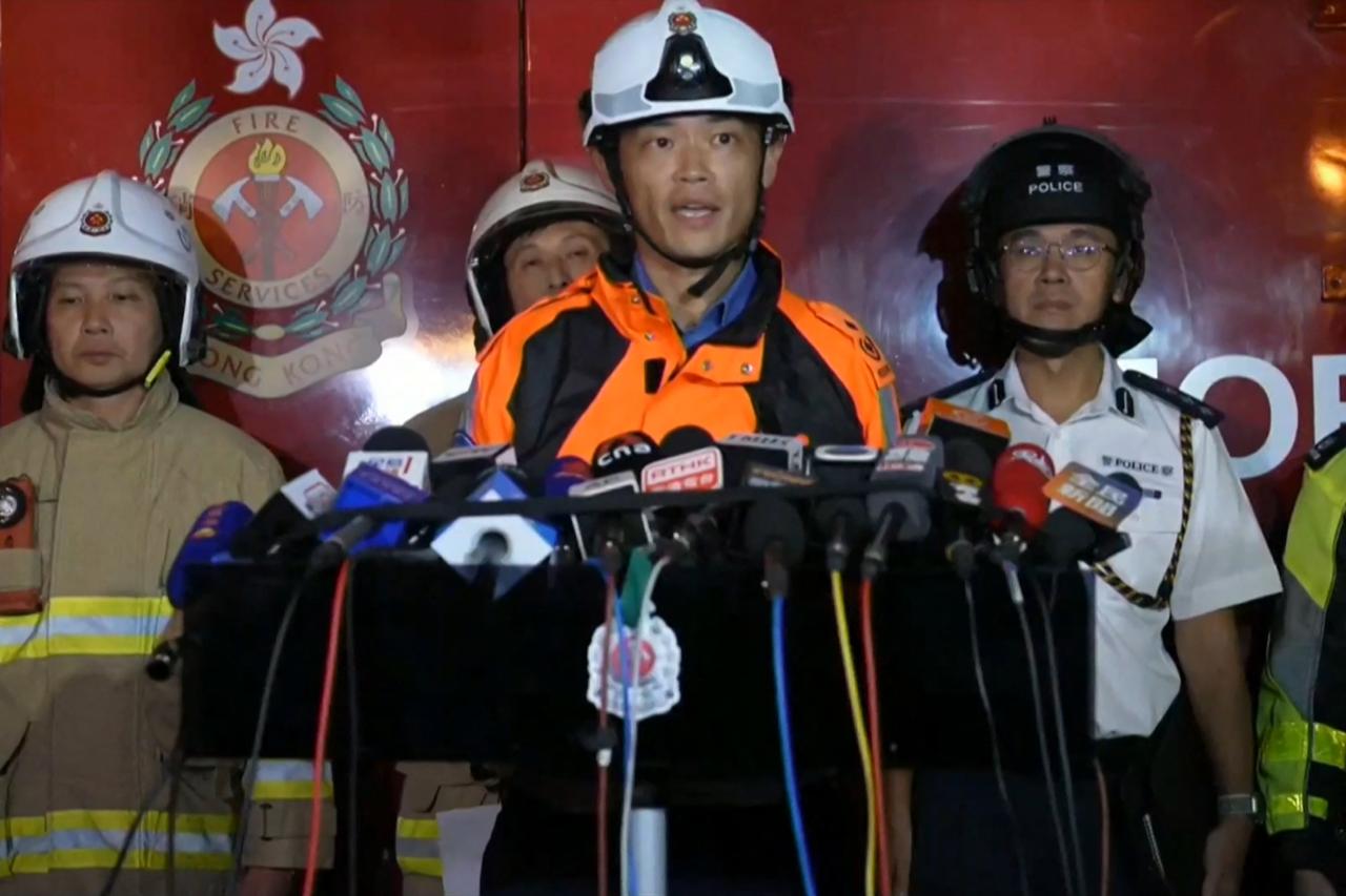 This frame grab from AFPTV video footage shows Chou Wing-yin, assistant chief ambulance officer (New Territories East), speaking to media amid ongoing operations to control a major fire at the Wang Fuk Court residential estate in Hong Kong's Tai Po district on Nov. 26, 2025. (AFP Photo)