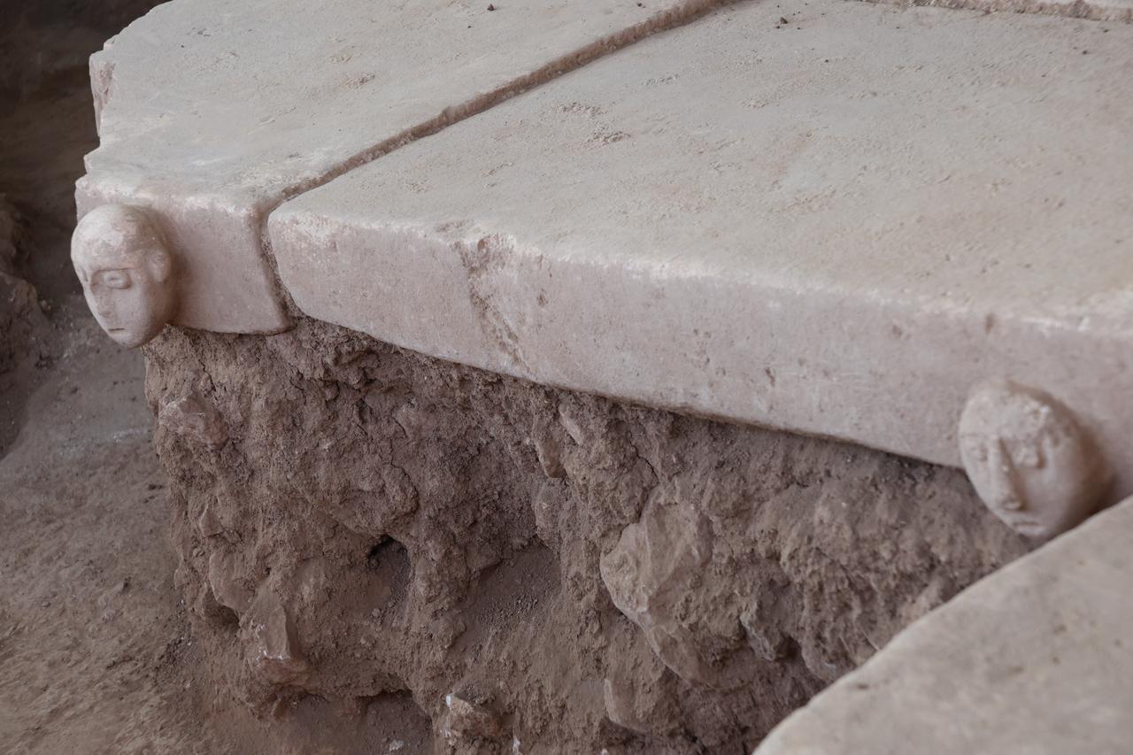 Two carved human heads positioned at the edges of a stone platform, suggesting a deliberate symbolic placement within the architectural context. (Photo via Sefertepe Excavations)