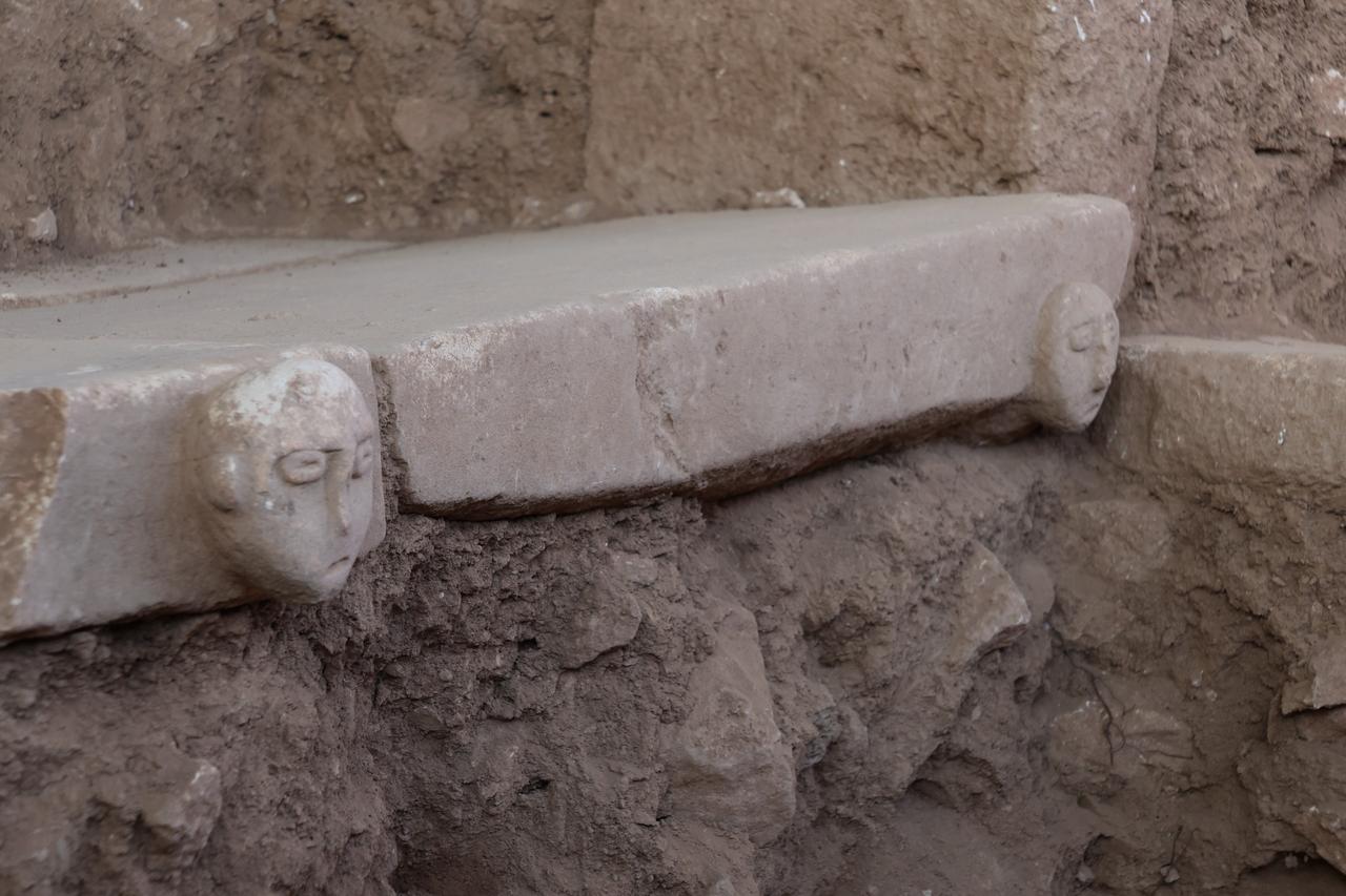 Two carved human heads positioned at the edges of a stone platform, suggesting a deliberate symbolic placement within the architectural context. (Photo via Sefertepe Excavations)