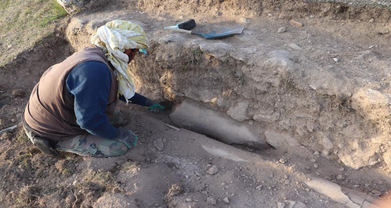 An archaeologist exposes the torso of a Roman-era statue embedded in the stadium wall during ongoing excavations at the ancient city of Blaundos in Usak, western Türkiye, Nov. 25, 2025. (Photo via Blaundos Excavations)