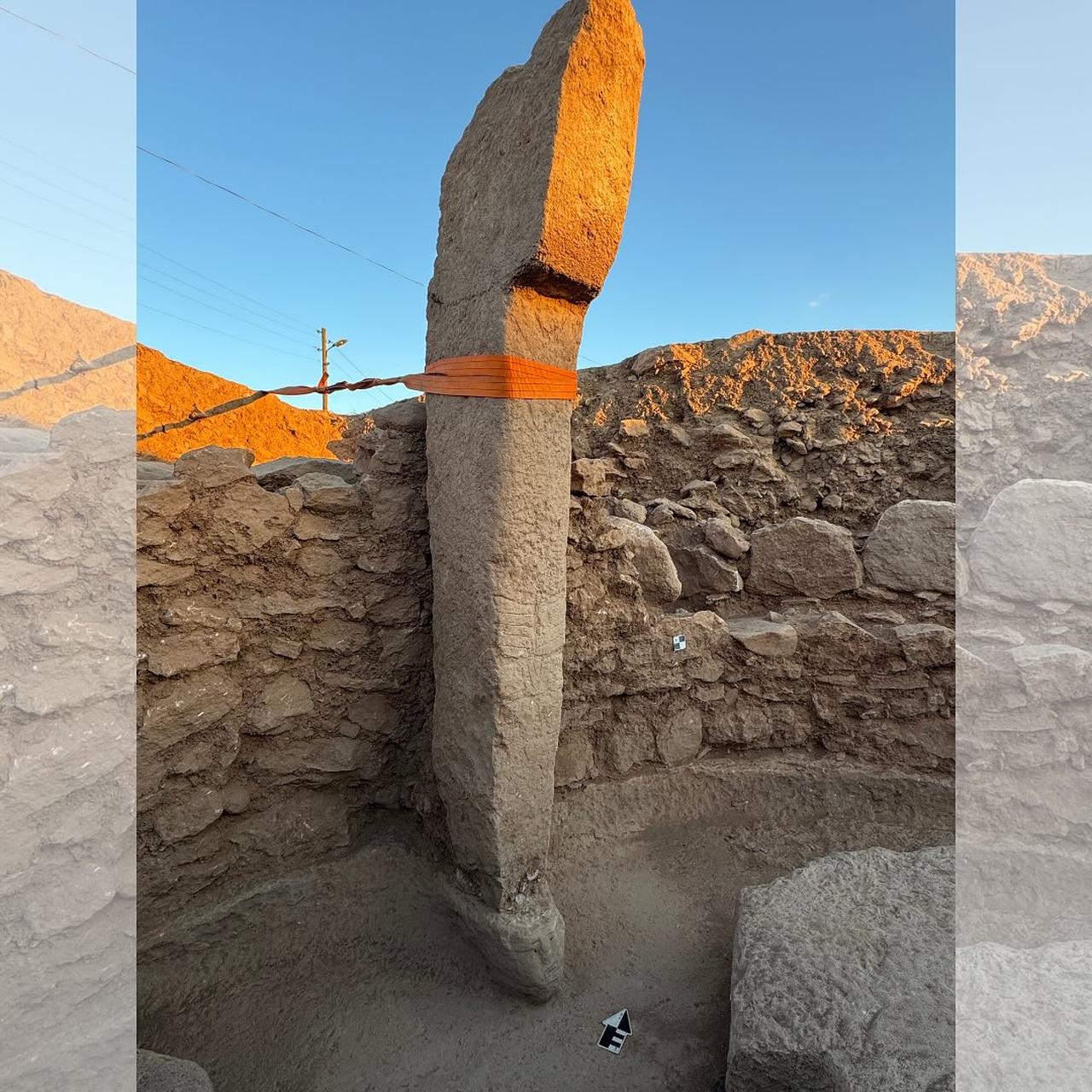 View of a tall upright pillar strapped for preservation, standing opposite a niche, where symbolic elements such as carvings and human remains have been identified. (Photo via Instagram/@arkeolojihaber)