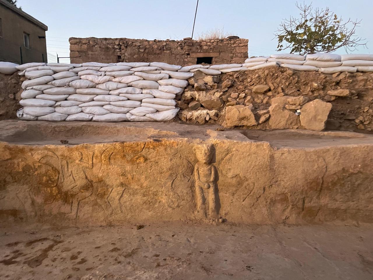 A wider evening view of the Sayburc excavation site, showing the alignment of pillars and preserved wall sections against the surrounding modern landscape. (Photo by Koray Erdogan/Türkiye Today)