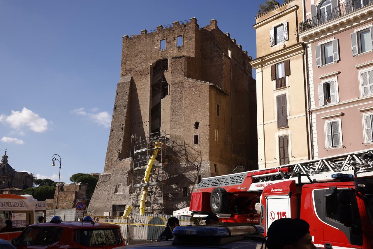 Fire trucks and ambulances gather outside the medieval tower as firefighters continue search and rescue operations. (AA Photo)
