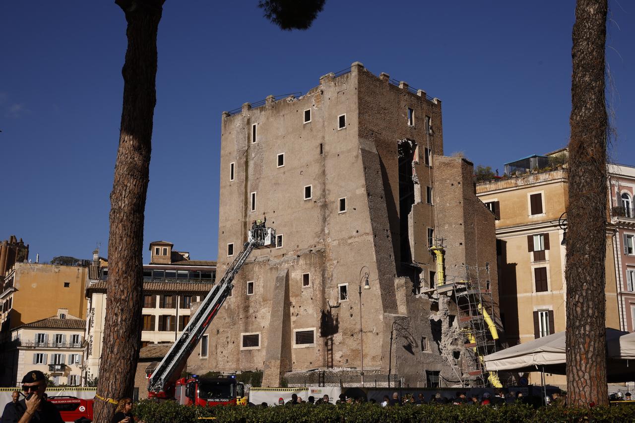 Firefighters work around the centuries-old tower near the Colosseum after part of the structure gave way during restoration works. (AA Photo)