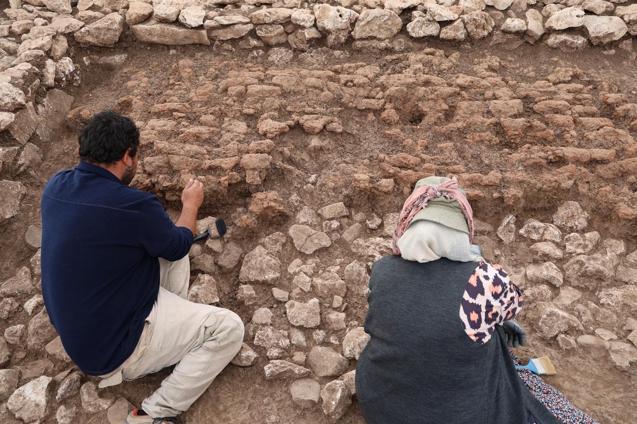 Archaeologists at work in the excavation area of Cayonu Hill near Ergani in southeastern Türkiye, where the remains of a 5,000-year-old structure collapsed during an ancient earthquake have been unearthed. (IHA Photo)