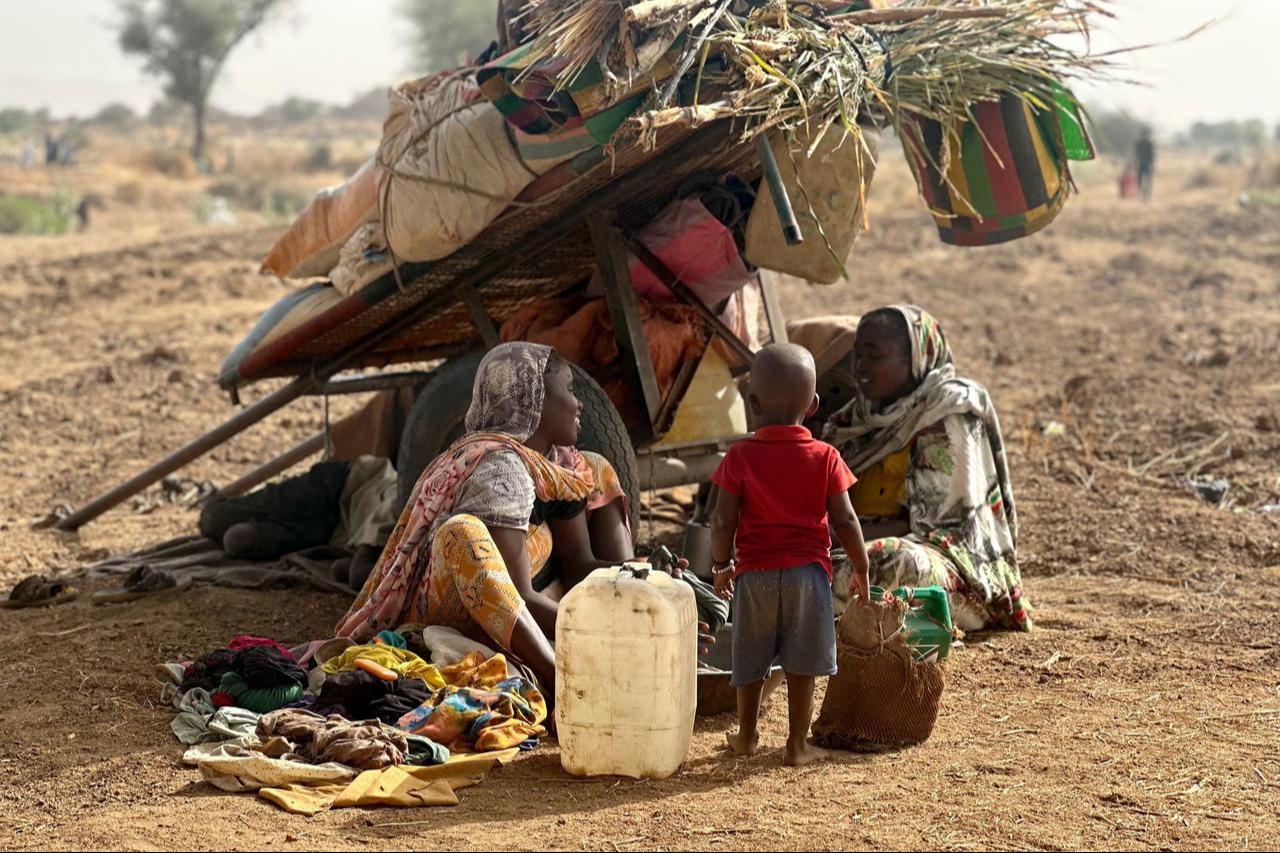 People who fled the Zamzam camp for the internally displaced after it fell under RSF control, rest in a makeshift encampment in an open field near the town of Tawila in war-torn western Darfur region, Sudan, on April 13, 2025. (AFP Photo)