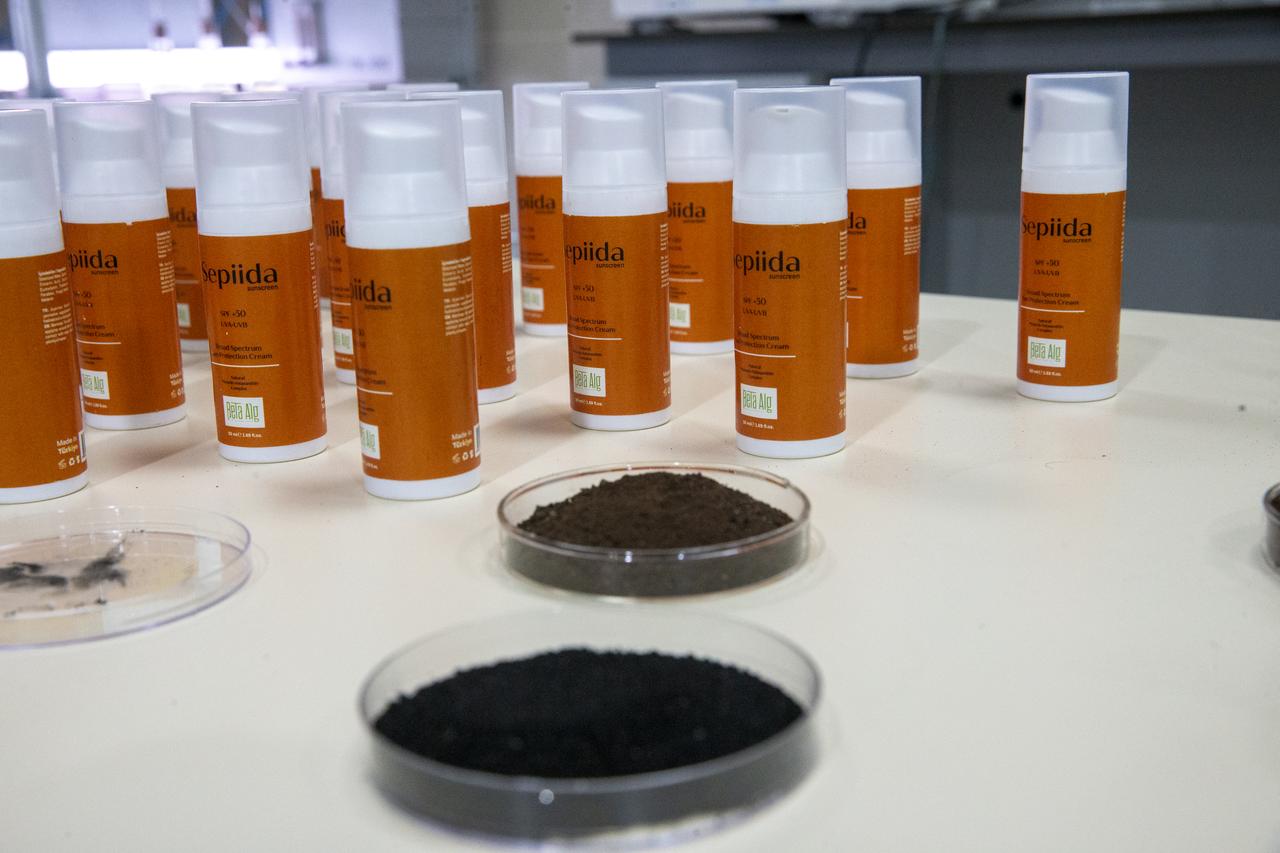Bottles of the newly developed natural sunscreen, branded “Sepiida,” are displayed alongside samples of cuttlefish-derived melanin pigment in a laboratory in Türkiye. (AA Photo)