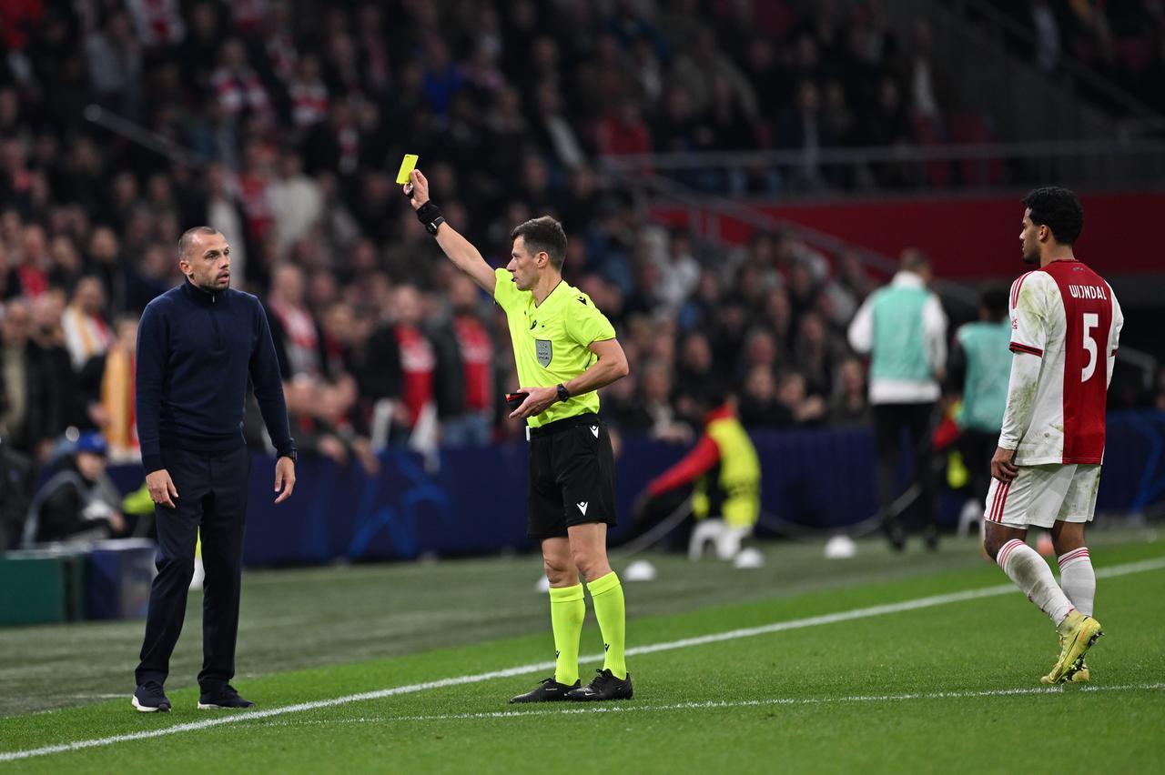Referee Benoit Bastien shows a yellow card to Ajax head coach John Heitinga during the UEFA Champions League week 4 match between Ajax and Galatasaray at Johan Cruijff Arena in Amsterdam, Netherlands, November 5, 2025. (AA Photo)