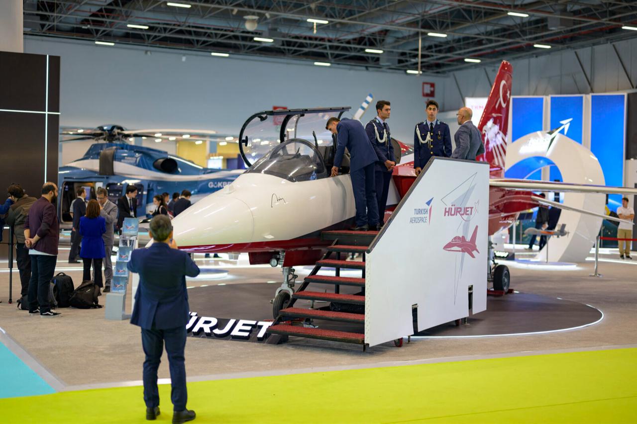 People look at the advanced Jet trainer light attack Aircraft ''Hurjet'' during the opening day of the International Defense and Aerospace exhibition in Istanbul, on October 22, 2024. (AFP Photo)