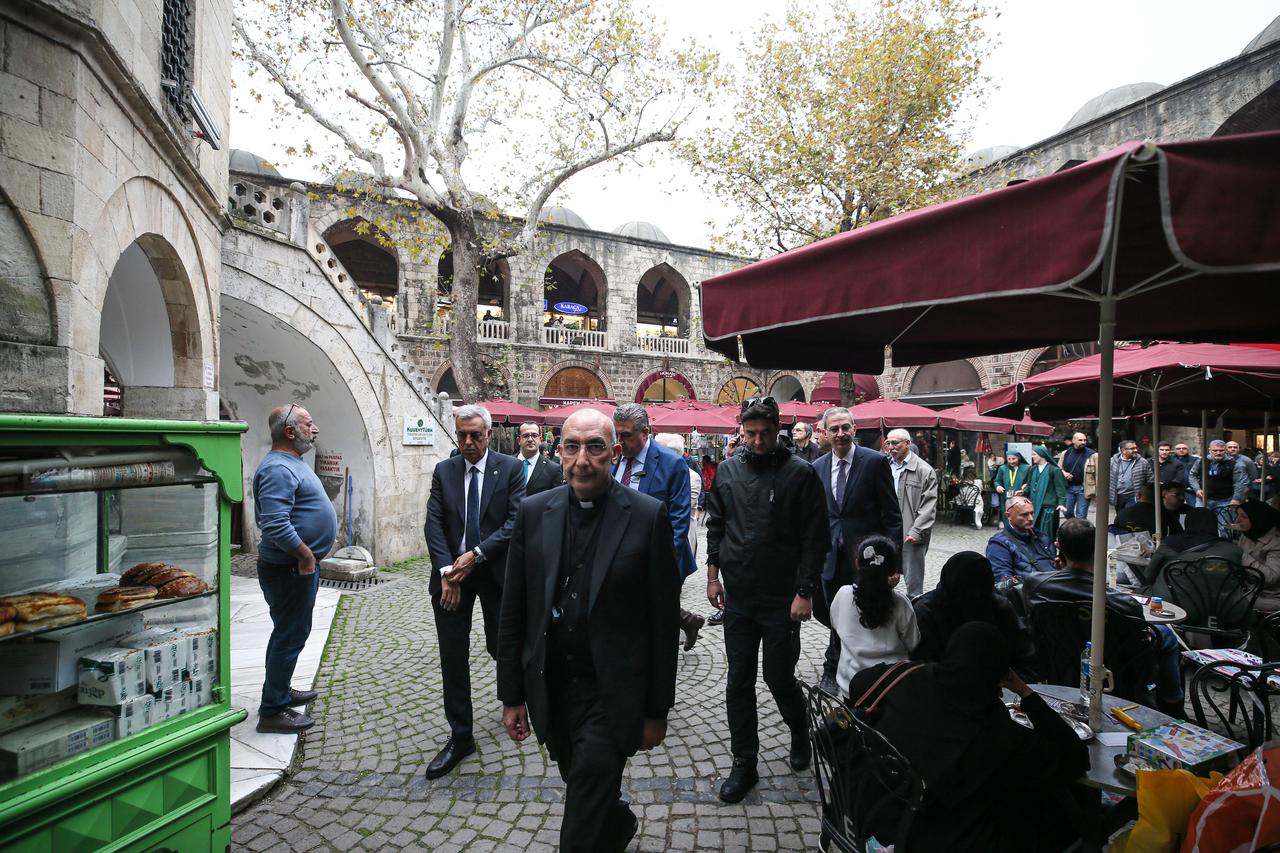 Vatican delegation that includes the Pope’s Vicar General, Cardinal Baldassare Reina (front), visit historic caravanserai Koza Han in Bursa, Türkiye, Nov. 5, 2025. (AA Photo)