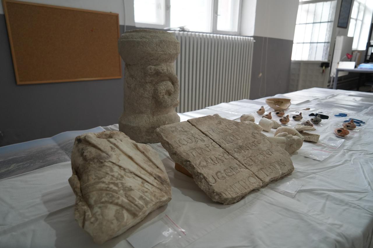 Archaeological finds from the Roman Pool excavations displayed for study, including the newly uncovered a carved altar featuring the sacred snake motif associated with the healing god Asklepios, inscription and sculptural fragments, Nov. 7, 2025. (IHA Photo)