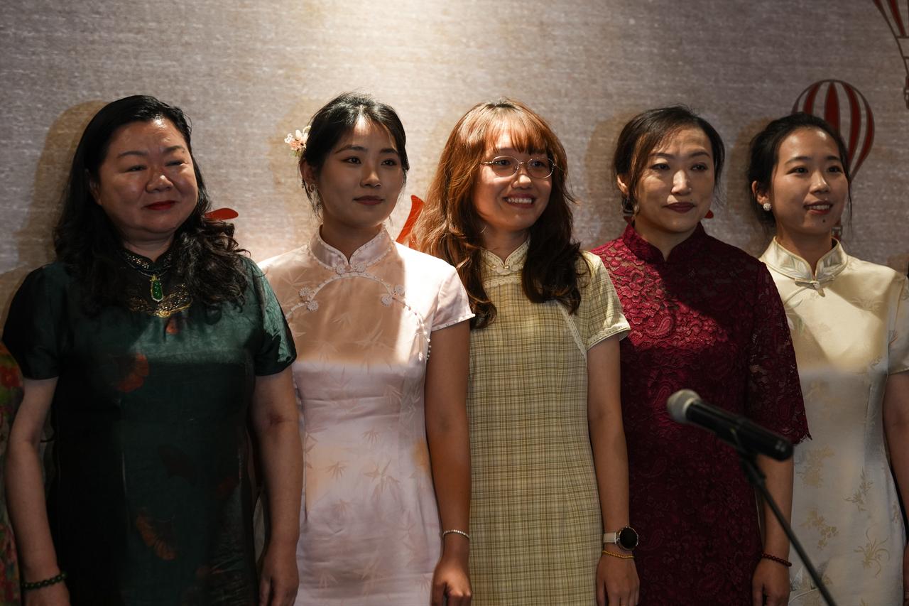 Participants wearing traditional Chinese dresses pose for a photo during the China–Türkiye Gastronomy Festival in Ankara, Türkiye, Nov. 6, 2025. (AA Photo)