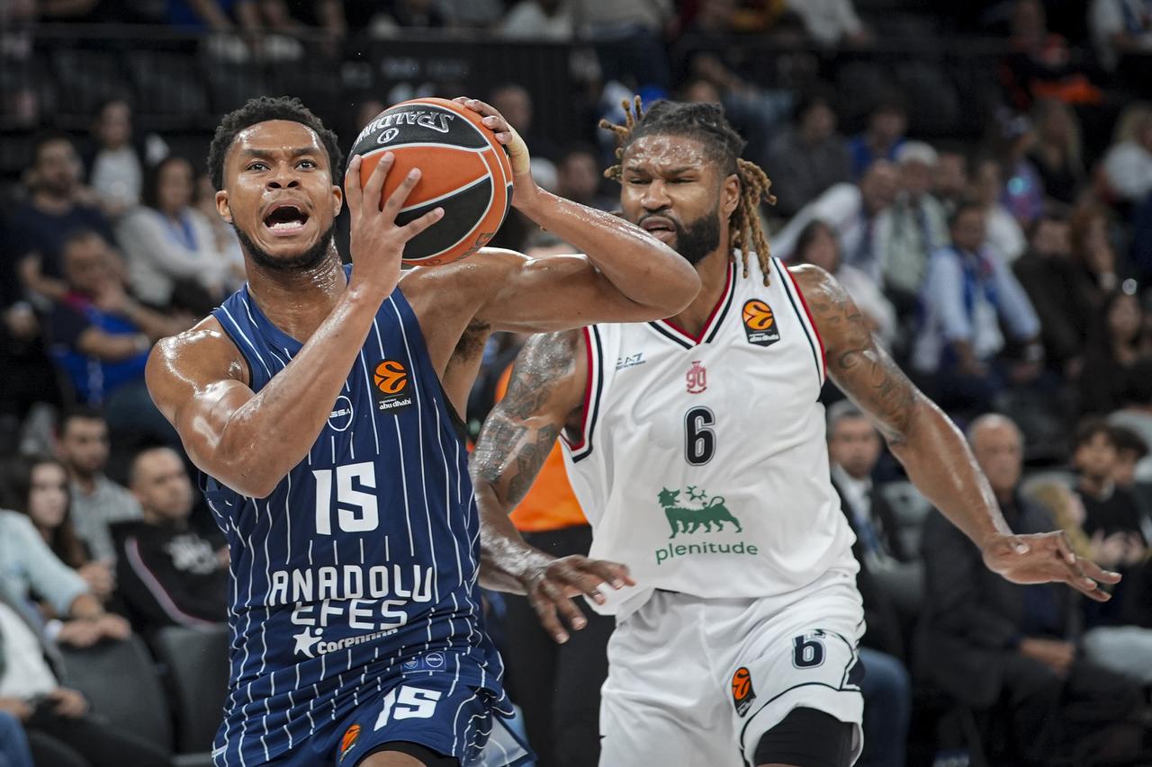 P.J. Dozier (L) of Anadolu Efes in action against Devin Booker (6) of EA7 Emporio Armani Milan during the EuroLeague Week 9 basketball match between Anadolu Efes and EA7 Emporio Armani Milan at the Turkcell Basketball Development Center in Istanbul, Türkiye, on Nov. 07, 2025. (AA Photo)