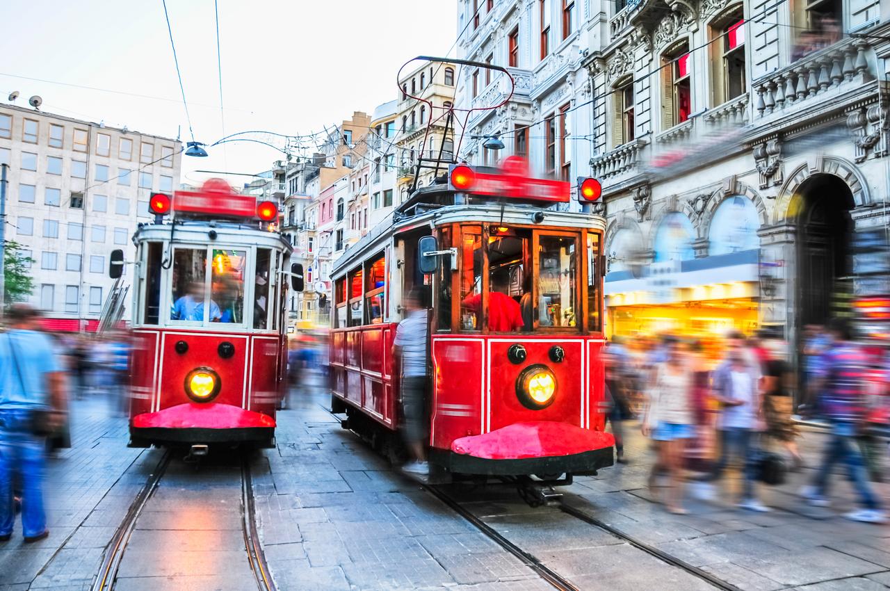 Historic red trams on Istiklal Avenue in Istanbul, Türkiye. (Adobe Stock Photo)