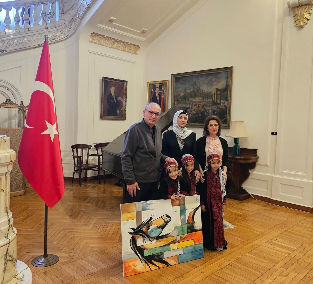 Ambassador of Türkiye to Cairo, Salih Mutlu Sen, with the Gazan painter Feyza Yusuf El Raddie and her triplets at the ambassadorial residence , 5 November 2025 . ( Photo via Turkish embassy in Caito )