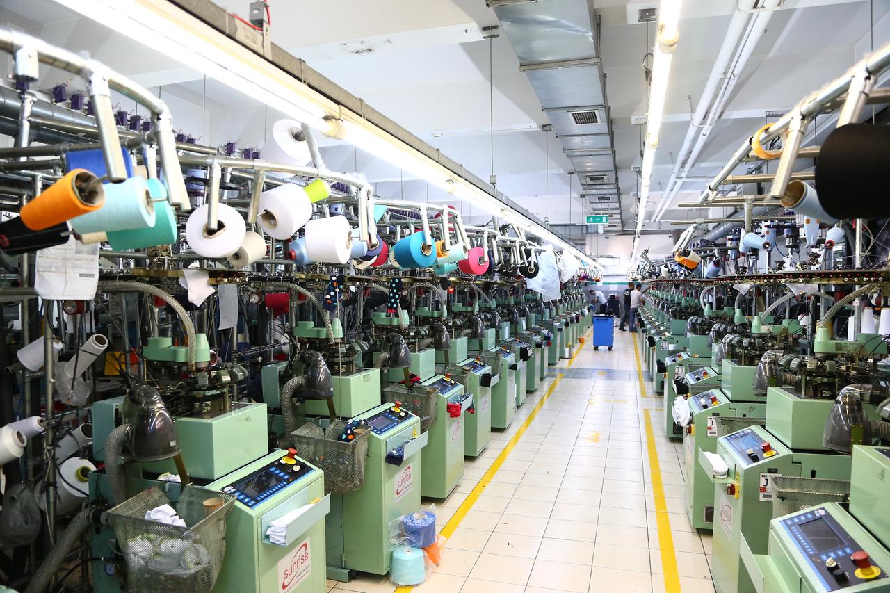 Workers operate textile machinery at a manufacturing facility in Türkiye. (Adobe Stock Photo)