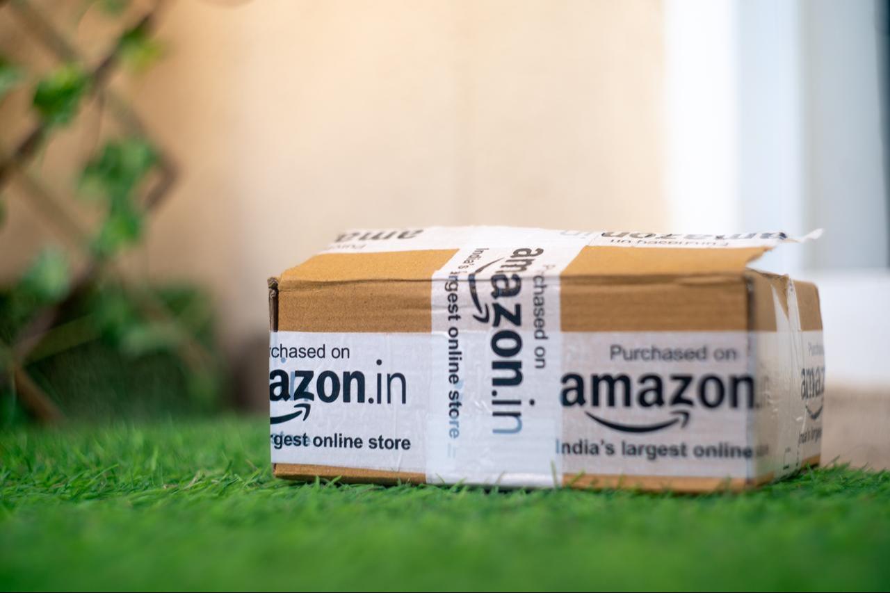 A cardboard delivery package from Amazon India placed in front of a house entrance in New Delhi, India, in 2020. (Adobe Stock Photo)