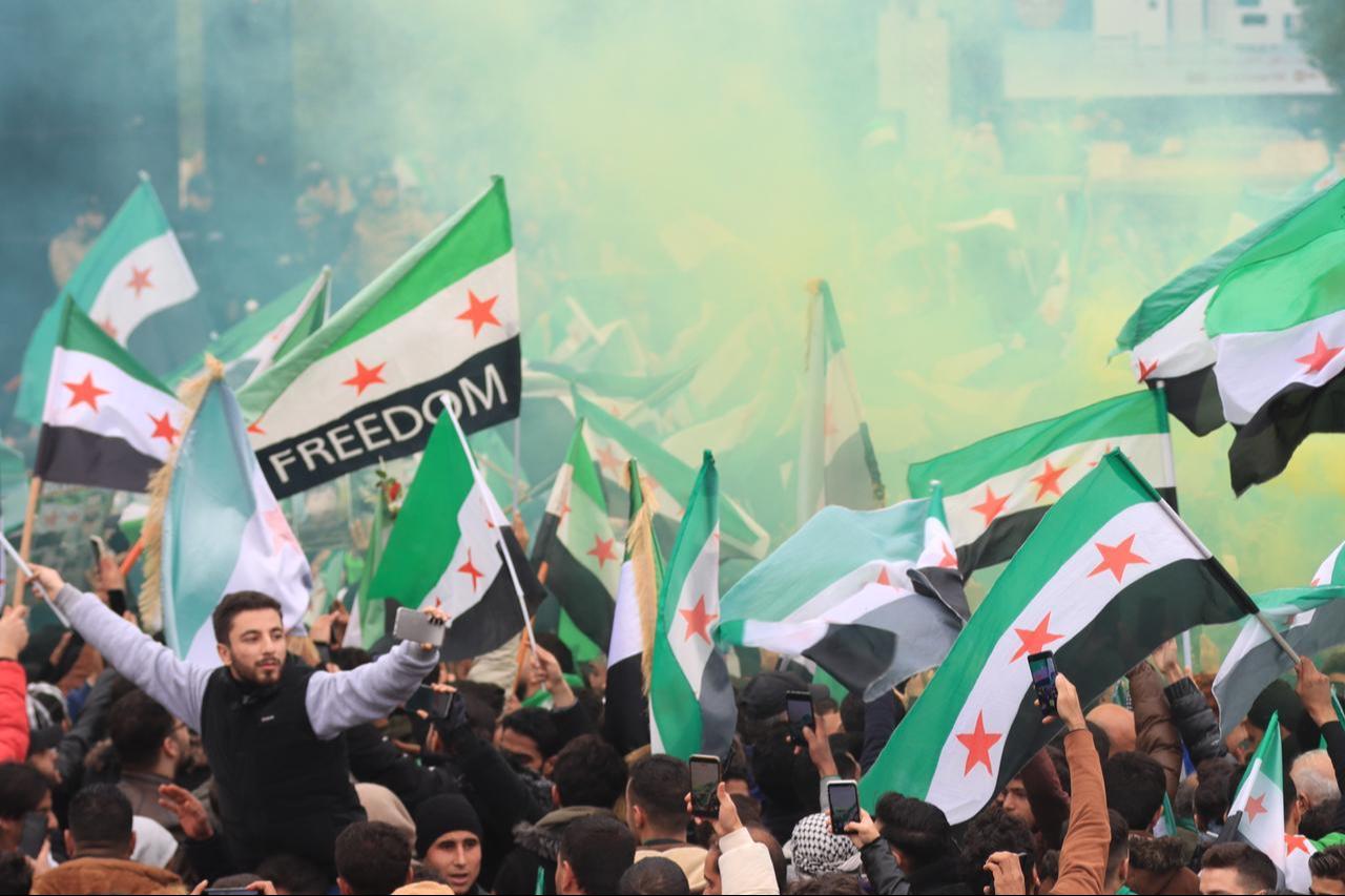 Syrian people gather to celebrate the first anniversary of the fall of Bashar al-Assads regime in Aleppo, Syria on December 08, 2025.( AA Photo  )