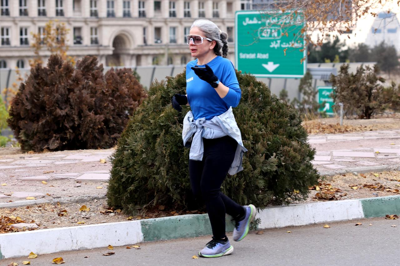 An Iranian woman jogs in the grounds of the 270-hectare Pardisan Park, in the northwest of Tehran, on December 8, 2025. (AFP Photo)