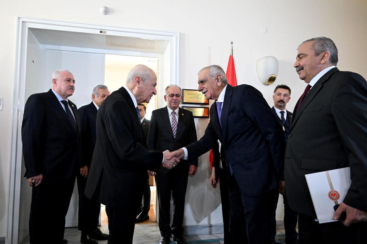 MHP Chairman Devlet Bahceli shakes hands with DEM Party member Ahmet Turk following private meeting at the Turkish Parliament, Ankara. January 2025.  Widely interpreted as a pivotal moment in MHP and DEM Party normalizing ties. (IHA Photo)