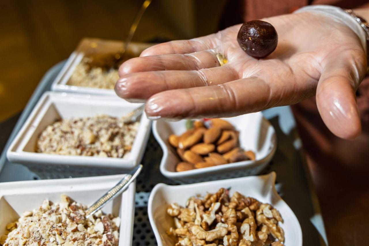 Ayten Yavuz shapes a chocolate piece by hand during production at the atelier, Ankara, Türkiye, December 11, 2025. (Courtesy of European Union)