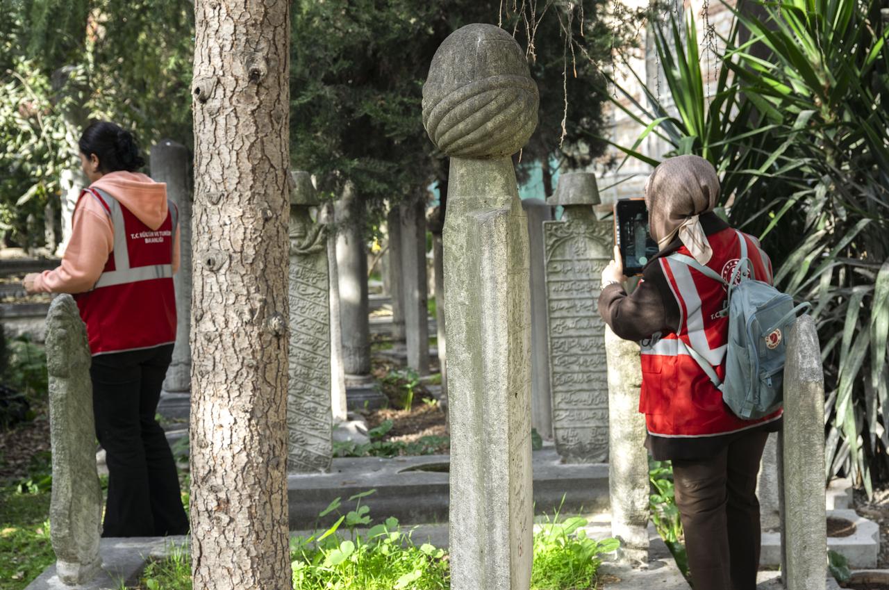Members of the documentation team continue photographing and cataloguing centuries-old tombstones as part of the Islamic Inscriptions and Tombstones Inventory Project at Seyh Devati Mustafa Efendi Mosque cemetery in Uskudar, Istanbul, Türkiye, Dec. 11, 2025. (AA Photo)