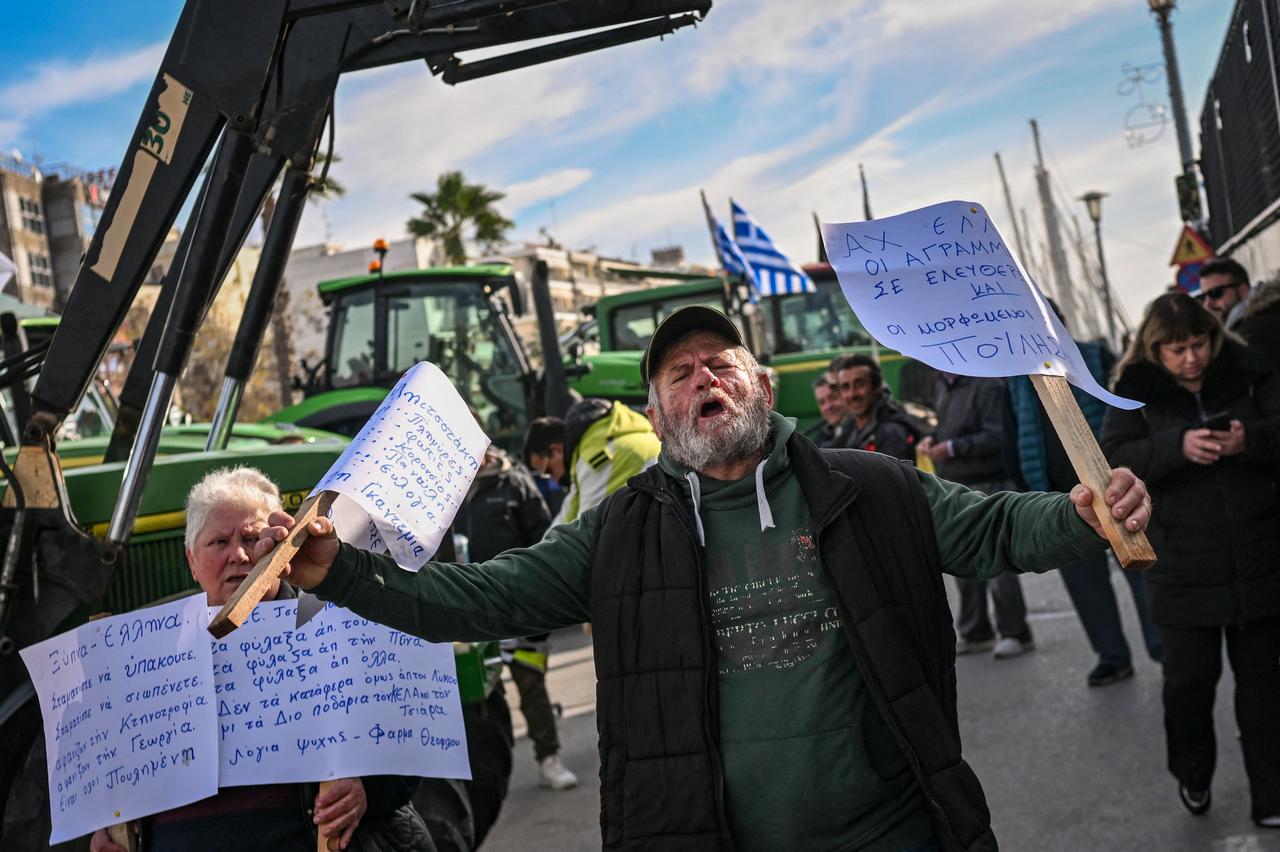 A farmer shouts slogans and holds placards as he takes part in the blocking of the passengers' port of Volos during a demonstration, Greece, December 10, 2025. (AFP Photo)