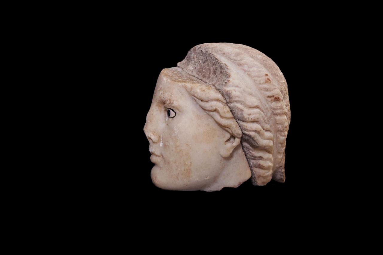 The marble head of a Hellenistic-era goddess from Metropolis is shown after cleaning, revealing detailed facial features in an ancient commercial district near Izmir, western Türkiye, Dec. 11, 2025. (AA Photo)