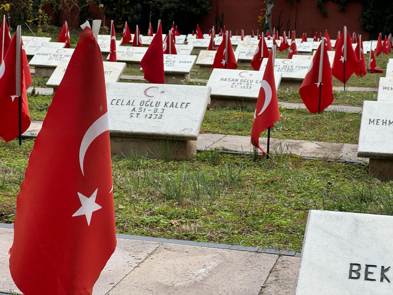 Turkish flags stand beside marble headstones at the Turkish Martyrs’ Cemetery in Bucharest, Romania, Dec. 12, 2025. (AA Photo)