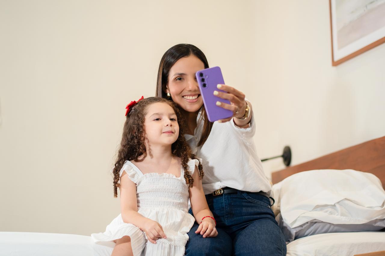 A mother takes a selfie with her young child, illustrating how everyday family moments can quickly become shareable online. (Adobe Stock Photo)