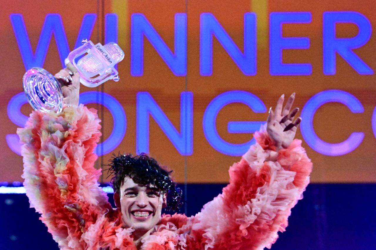 Swiss singer Nemo representing Switzerland with the song "The Code" celebrates on stage with his trophy after winning the final of the 68th Eurovision Song Contest (ESC) at the Malmo Arena in Malmo, Sweden on May 11, 2024. (AFP File Photo)