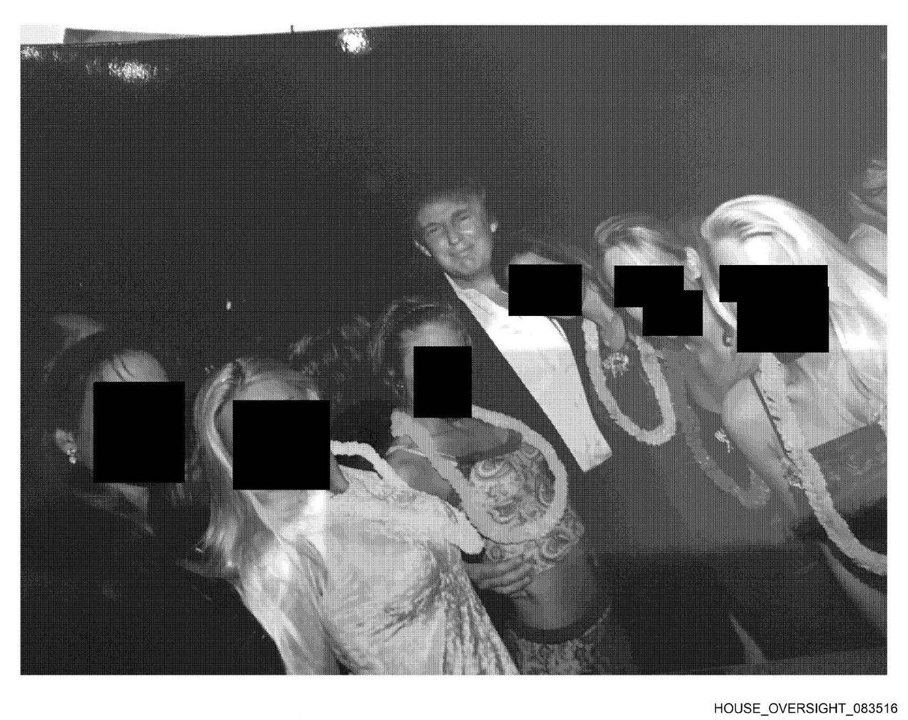 Photo of US President Donald Trump (C) posing with a group of women wearing Hawaiian-style leis shared by Democrats on Dec. 12, 2025. (Photo via House Oversight Committee)