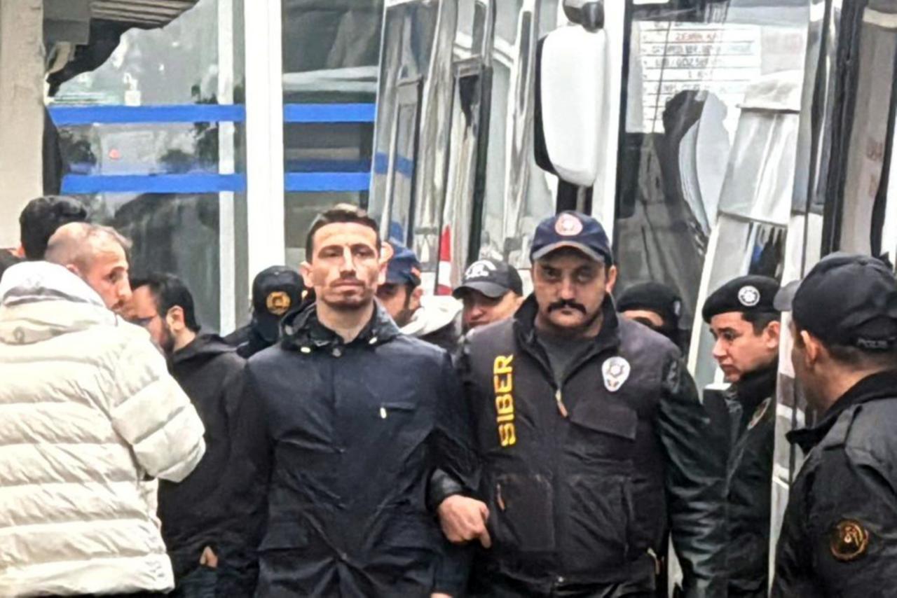 Fenerbahce midfielder Mert Hakan Yandas is escorted by cybercrime police officers following his arrest over alleged involvement in a betting scandal in Istanbul, Türkiye, December 8, 2025. (AA Photo)